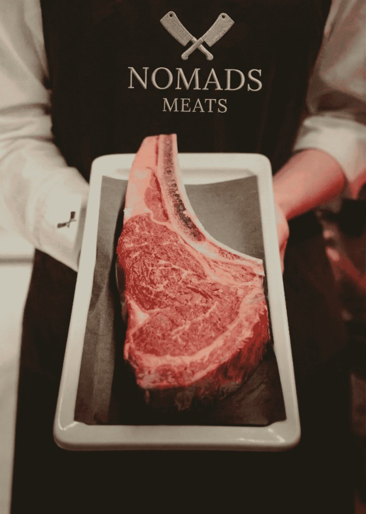 Nomads Meats butcher presenting a premium tomahawk steak
