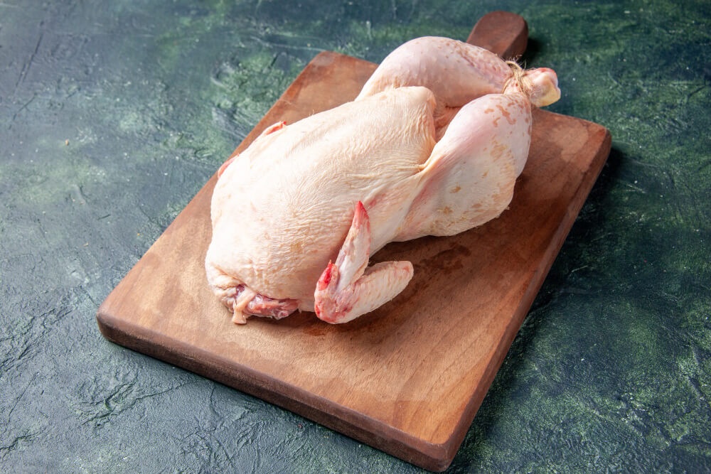 Whole fresh duck on a cutting board
